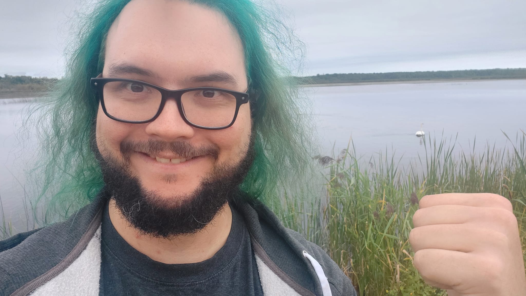 A man with green hair is visiting a freshwater marsh, photo 7